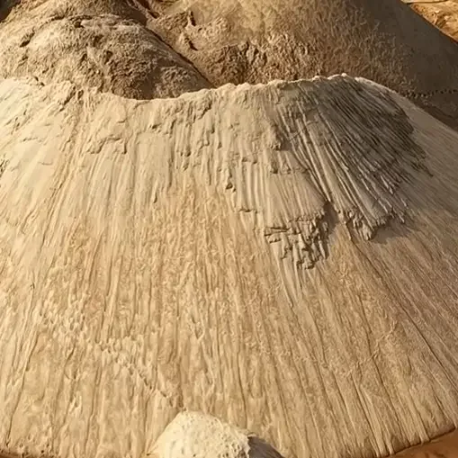 Close-up of clean dam-dredged river sand particles showing quality and texture